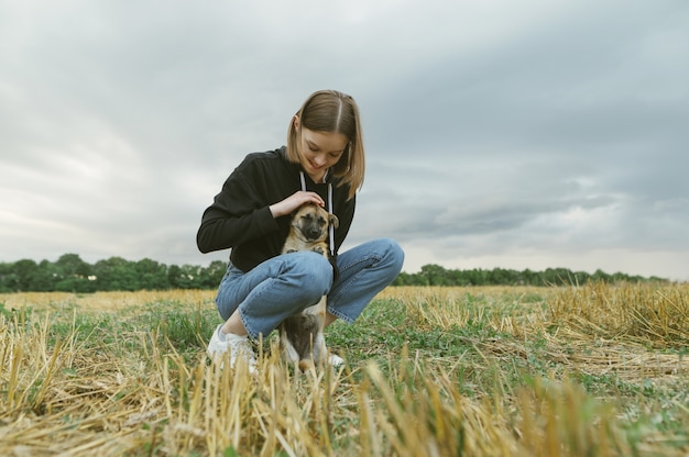 Dueño de la hermosa niña y perrito en un campo biselado