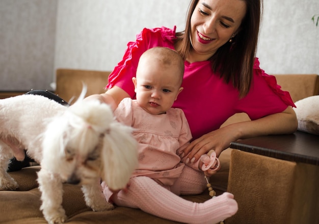 Dulce joven madre pasa tiempo con su hija y cachorro