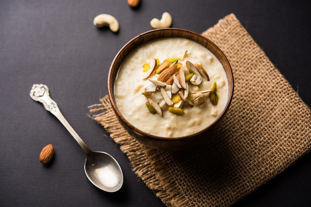 Dulce Rabdi o Lachha Rabri o basundi, elaborado con leche pura aderezada con frutos secos. Servido en un bol sobre fondo de mal humor. Enfoque selectivo