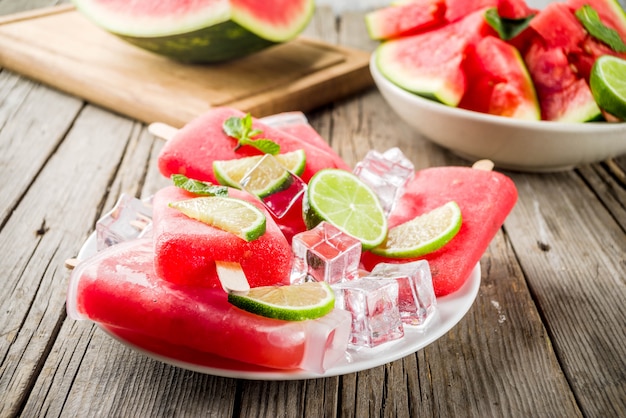 Dulces paletas de sandía y lima de verano con sandía en rodajas y menta