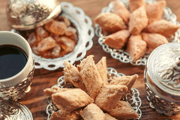 Dulces turcos con café en una mesa de madera