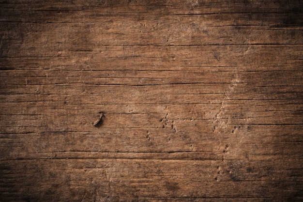 Foto dunkler strukturierter holzhintergrund des alten schmutzes, die oberfläche der alten braunen holzbeschaffenheit, draufsicht braune teakholzverkleidung