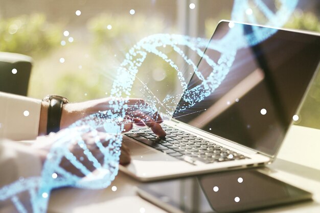 Foto dupla exposição de holograma de dna criativo e mãos digitando em laptop no conceito de bio engenharia e pesquisa de dna