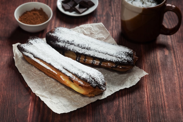 Eclairs de chocolate em papel pergaminho