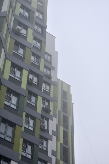 Edificio de apartamentos de gran altura en la niebla