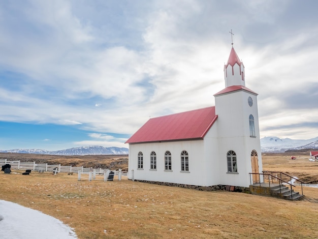 Edificio de arquitectura clásica de la iglesia helgafell de la iglesia de islandia en la colina bajo un cielo azul nublado