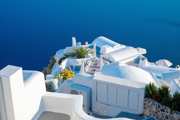 Edificio blanco contra el cielo azul y el mar en la isla de Santorini, Oia, Grecia