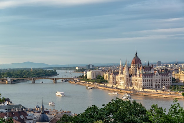 Foto edifício do parlamento húngaro ao lado do rio danúbio na cidade