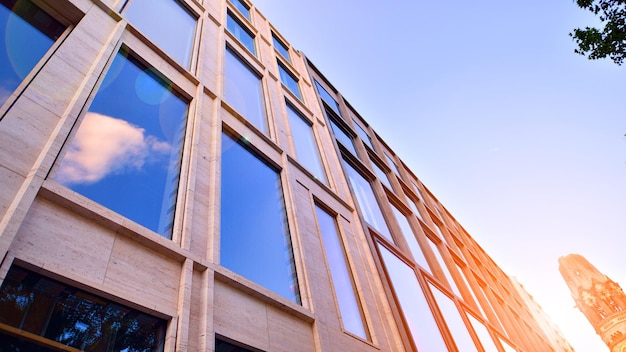 Edificio de oficinas moderno con fachada de vidrio sobre un fondo de cielo despejado Pared de vidrio transparente