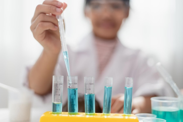 Educación ciencia química y niños concepto niños o estudiantes con tubo de ensayo haciendo experimentos en el laboratorio escolar