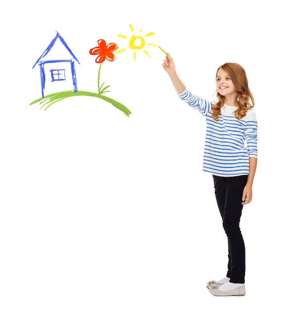 educación, escuela y concepto de gente feliz - linda niñita dibujando casa, flor y sol en el aire