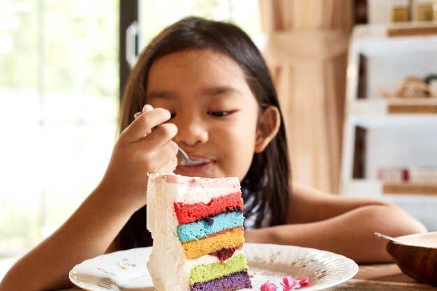 Eeating Kuchen des asiatischen Mädchens im Café.