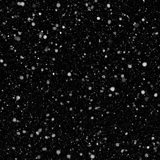 Efecto de textura de nieve blanca natural aislada en el fondo de la noche negra