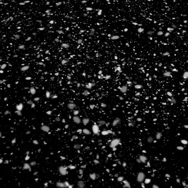 Foto efecto de textura de nieve blanca natural aislado sobre fondo de noche negra