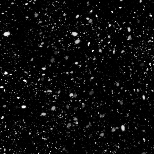 Foto efecto de textura de nieve blanca natural aislado sobre fondo de noche negra