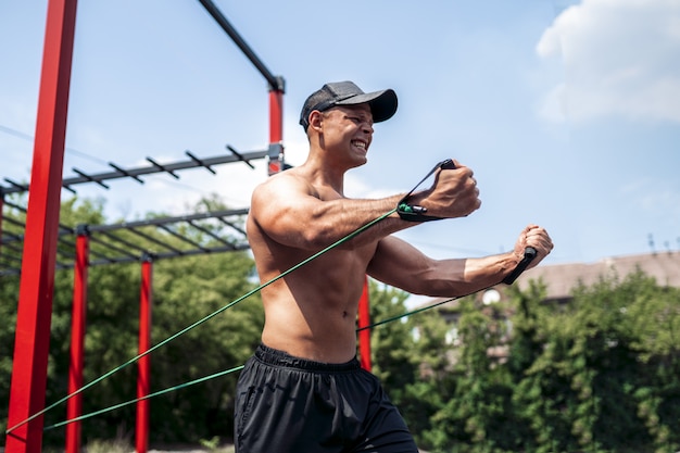 Eignungsmann-Trainingskasten mit Widerstandbändern am Straßenturnhallenyard. Training im Freien. Körpertraining mit Ausrüstung draußen. Gummiband-Zubehör.