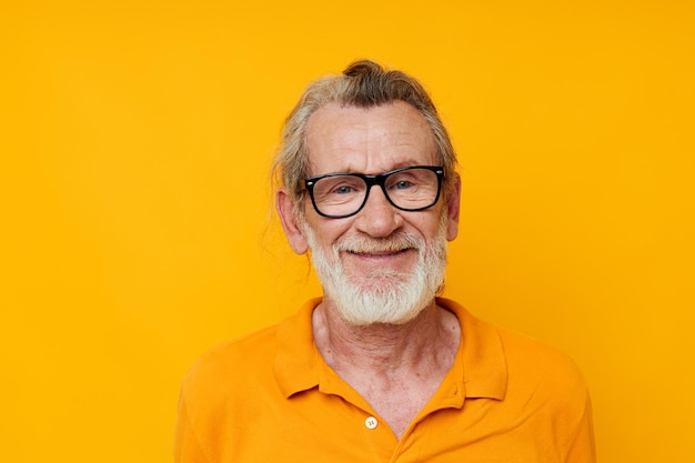 Ein älterer Mann mit Brille in einem gelben T-Shirt mit Brille in der Nähe