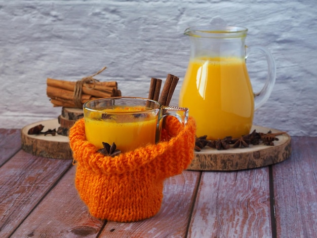 Ein Becher heiße goldene Milch auf einem Holztisch