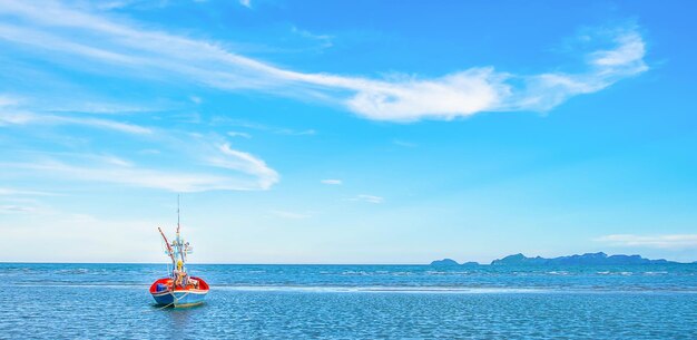 Ein Blick auf ein Fischerboot, das morgens am Meer festgemacht ist, mit einem wunderschönen blauen Meer und Himmel