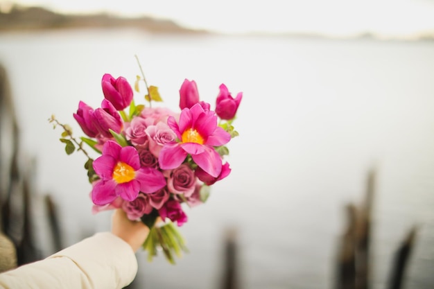 Ein Blumenstrauß wird von einer Person gehalten, die ihn hält.