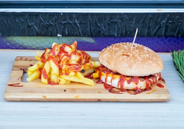 Ein Burger mit Ketchup sitzt auf einem Holzschneidebrett.