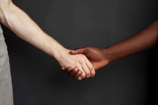 Ein fester Handschlag zwischen zwei Personen mit unterschiedlichem Hintergrund