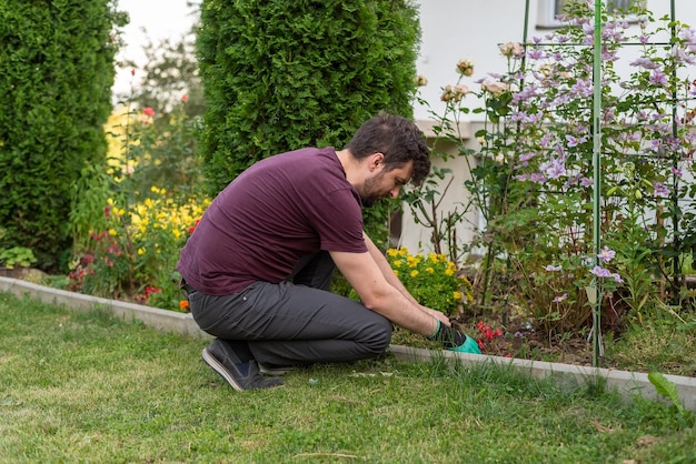 Ein Gärtnermann, der im Frühlingshof arbeitet