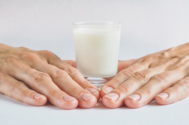 Ein Glas Bio-Milch auf einer weißen Oberfläche.