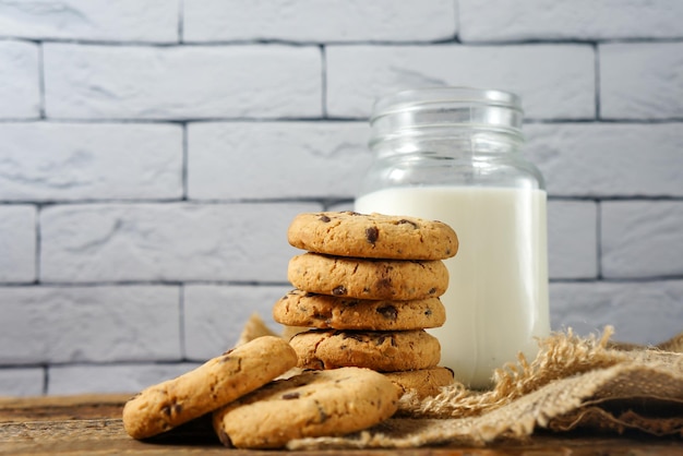 Ein Haufen köstlicher Schokoladenkekse auf einer Serviette mit einer Flasche Milch auf dem Küchentisch eine Kopie des Raums