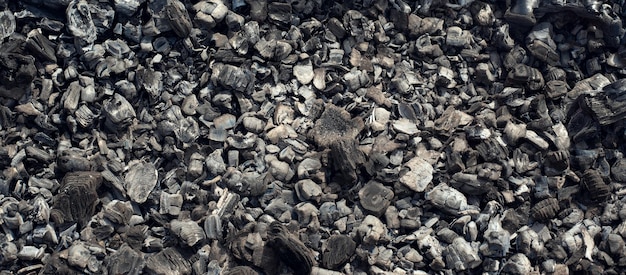 Ein Hintergrund der verstreuten Holzkohle Brennende Kohle Schwelende Kohle