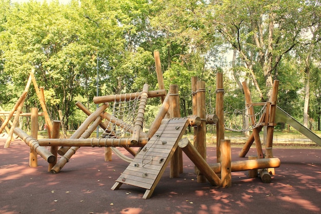 Ein hölzernes Klettergerüst mit einer Seilbrücke und einer Hängebrücke.