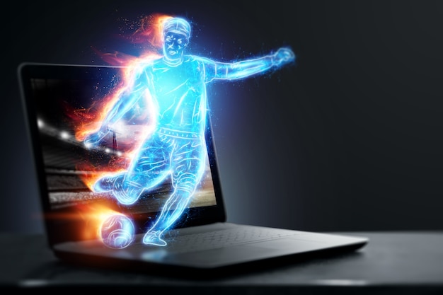 Ein Hologramm eines Fußballspielers, der aus einem Notebook, Laptop-Bildschirm läuft. Das Konzept von Sportwetten, Fußball, Glücksspiel, Online-Übertragung von Fußball.