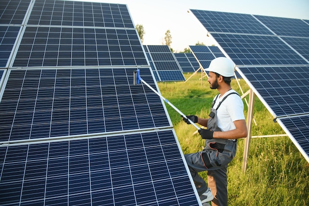 Ein indischer Handwerker reinigt Solaranlagen von Staub und Schmutz