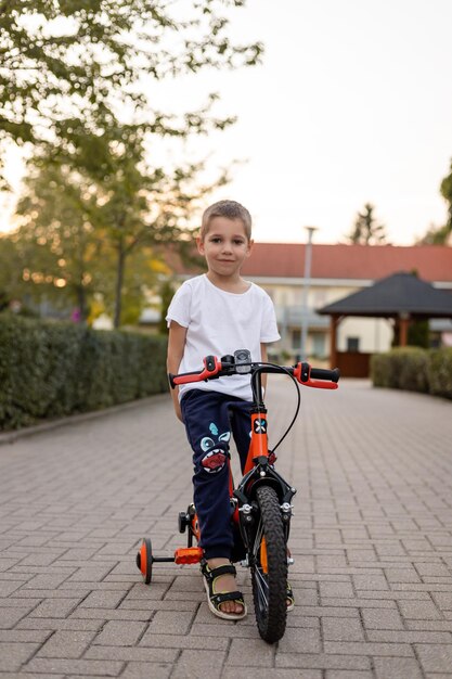 Foto ein junge auf einem fahrrad fährt die straße entlang ökologie kinderradfahren