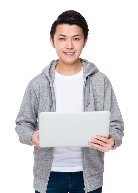 Ein junger asiatischer Mann arbeitet mit einem Notebook-Computer