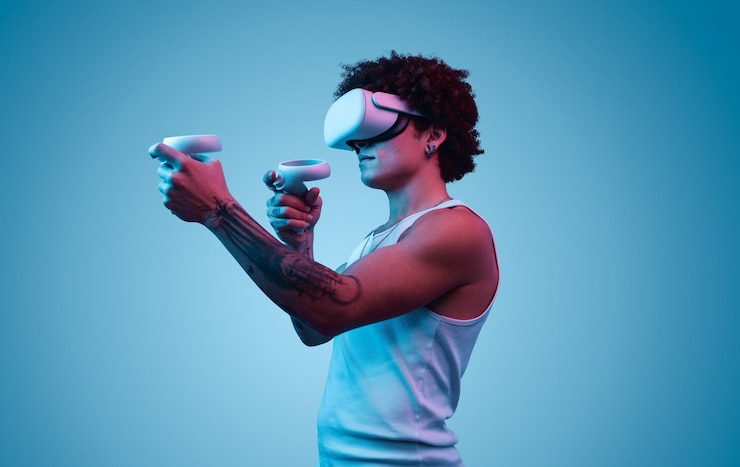 Foto ein junger ethnischer mann steht während des spiels in vr-brillen und controllern