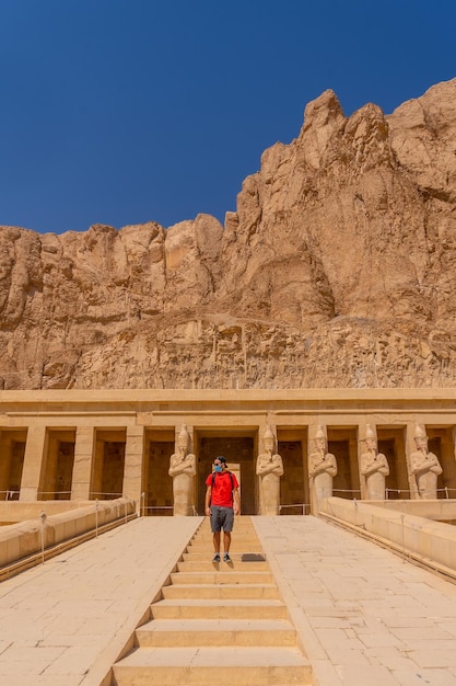 Ein junger Mann auf der Eingangstreppe zum Totentempel der Hatschepsut in Luxor