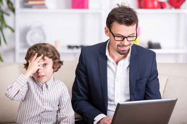 Ein junger Vater arbeitet am Computer.