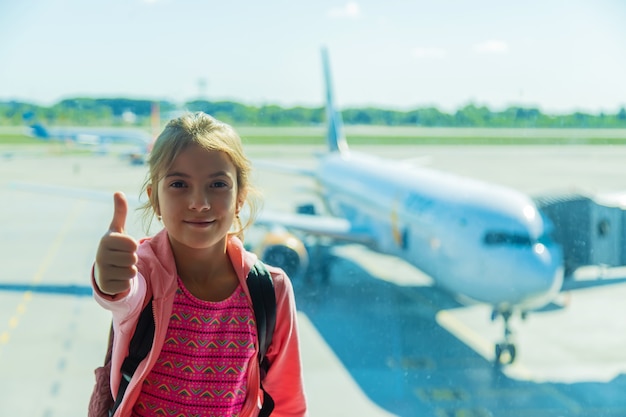 Ein Kind am Flughafen betrachtet das Flugzeug. Selektiver Fokus. Kind.