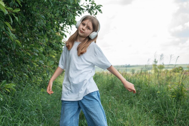 Foto ein kind mit kopfhörern, das musik hört und tanzt.