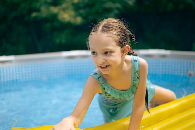 Ein kleines Mädchen liegt auf einem Schwimmbad
