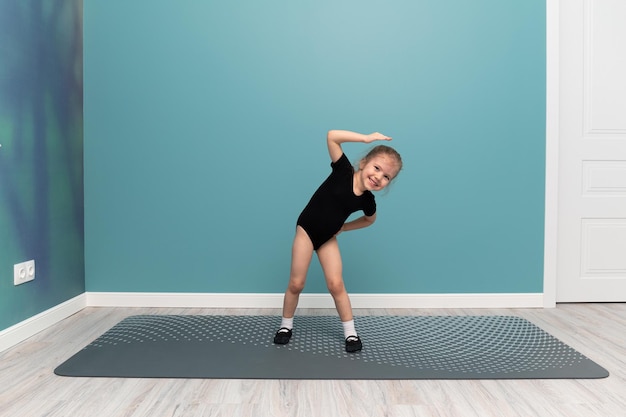 Ein kleines Mädchen macht Gymnastik Sport