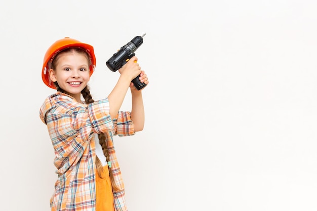 Ein kleines Mädchen mit einem Bohrer in den Händen, um Ihre Werbung auf einem weißen, isolierten Hintergrund zu zeigen Das Konzept der Renovierung im Kinderzimmer Kopieren Sie Platz