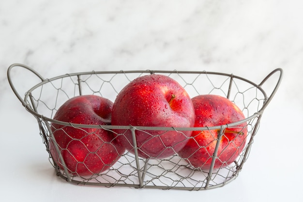 Ein Korb mit Früchten. Eine Reihe von Vitaminen. Ein Metallkorb mit Äpfeln. Vitamin. Vegetarisches, veganes Essen. Richtige Ernährung. Kohlenhydrate. Ein gesundes Set. Saftig schöne Äpfel