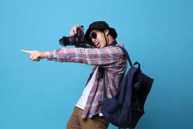 Foto ein lächelnder asiatischer fotograf macht bilder mit einer dslr-kamera