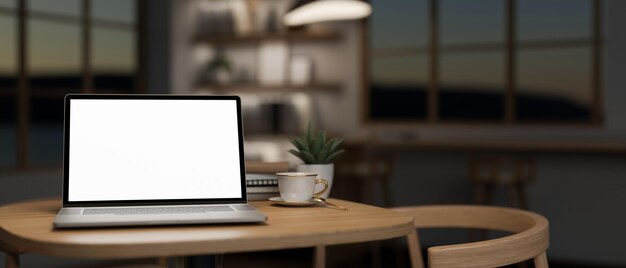 Foto ein laptop-computer-mockup auf einem holztisch in einem minimalistischen komfortablen kaffeehaus in der nacht