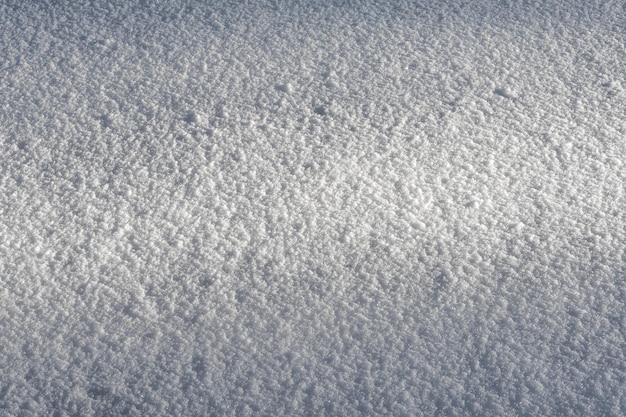 Foto ein lichtstrahl in der abenddämmerung auf einer flachen, schneebedeckten oberfläche schneemuster und -textur