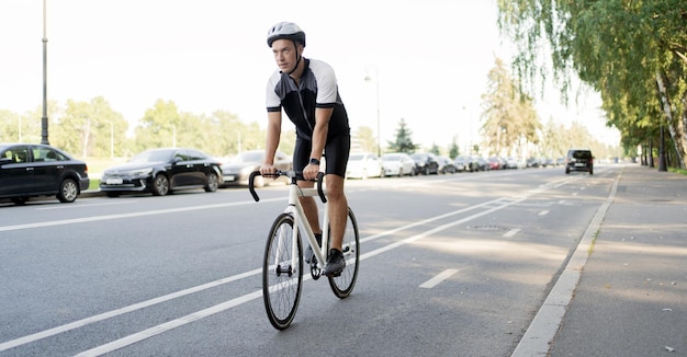 Ein männlicher Radfahrer mit Helm fährt Fahrradtraining in der Stadt