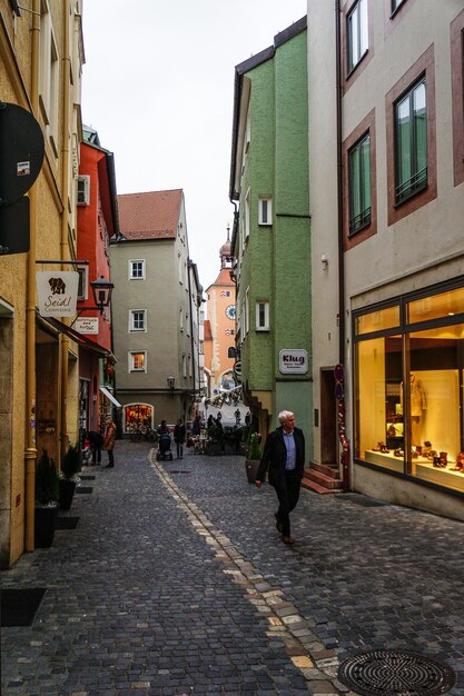 Ein Mann geht in der Dämmerung durch eine Gasse in der Stadt