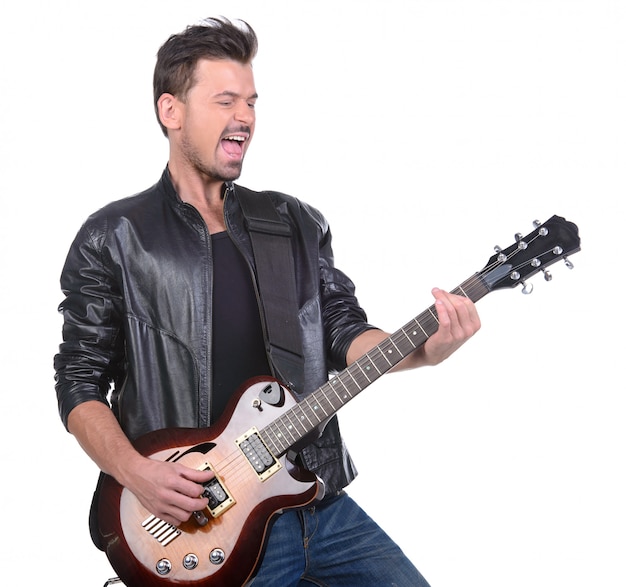 Ein Mann in einer Lederjacke spielt Gitarre.